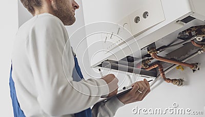 Professional plumber doing a boiler check Stock Photo