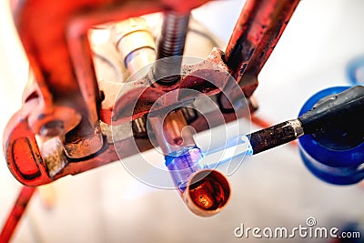 Professional plumber welding and soldering copper pipes Stock Photo