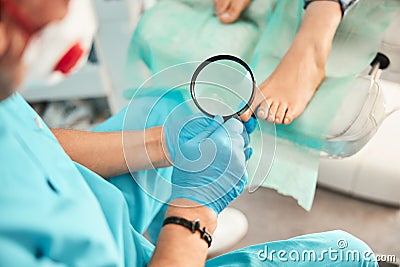 Close up of male hand holding magnifying glass Stock Photo