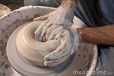 Professional potter making bowl in pottery workshop Stock Photo