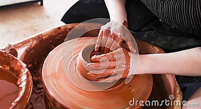 Professional potter making bowl in pottery workshop Stock Photo