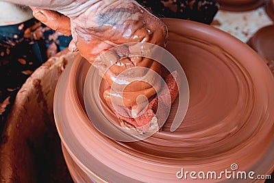 Professional potter making bowl in pottery workshop, studio Stock Photo