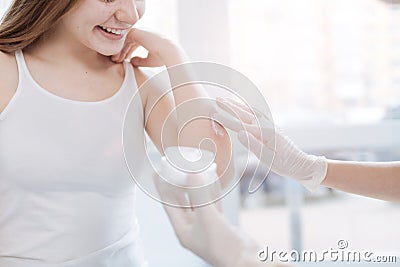 Professional practitioner testing new medical cream on patient skin at work Stock Photo