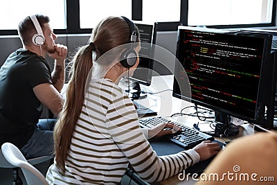 Programmers working with computers in office Stock Photo
