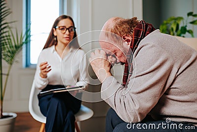 Professional psychiatrist and male patient having consultation in the office, Stock Photo