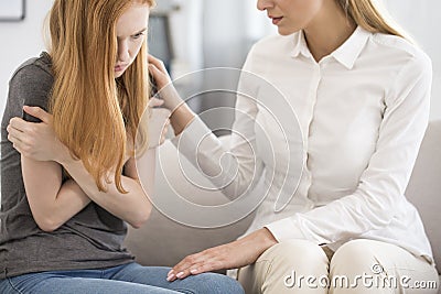 Professional psychologist comforting upset woman Stock Photo