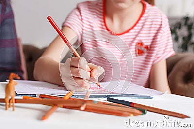 Professional psychologist with a teenage girl. Disclosing a child through a drawing. The method of work of a child psychotherapist Stock Photo