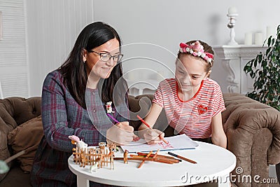 Professional psychologist with a teenage girl. Disclosing a child through a drawing. The method of work of a child psychotherapist Stock Photo