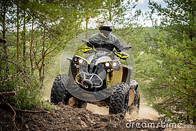 Professional quad biker rides in forest. Quad racing, ATV 4x4 Editorial Stock Photo