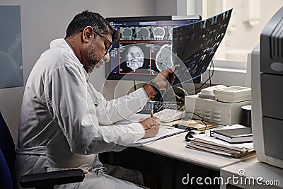 Doctor Working With CT Scan Results Stock Photo