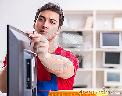 Professional repair engineer repairing broken tv Stock Photo