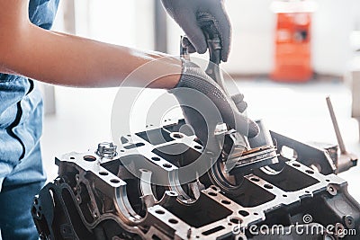 Professional repairman works with broken automobile engine Stock Photo