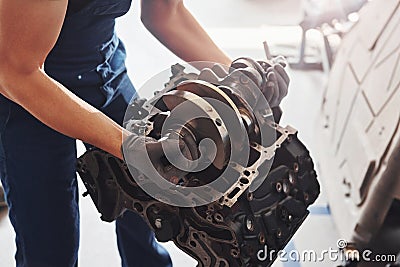 Professional repairman works with broken automobile engine Stock Photo