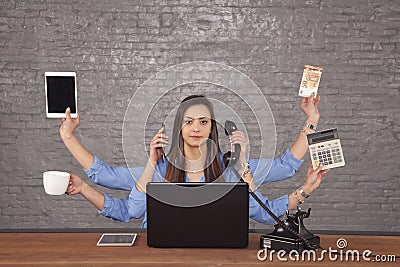 professional secretary has a large number of hands, a multi-tasking businesswoman concept Stock Photo