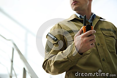 Professional security guard with portable radio set, closeup Stock Photo