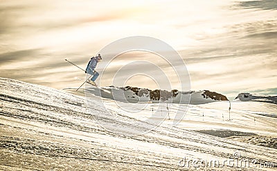 Professional skier performing acrobatic jump on downhill ride Stock Photo