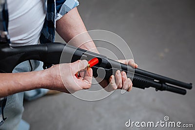 Professional skilled marksman loading his gun Stock Photo