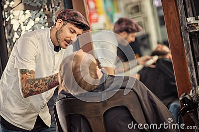 Professional skillful barber shaving beard Stock Photo