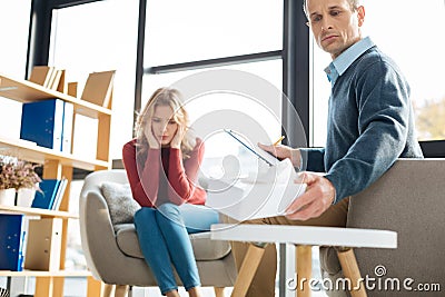 Professional skillful psychologist looking at the paper tissues Stock Photo