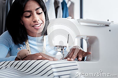 Professional skillful tailor sewing a dress Stock Photo
