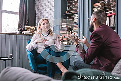 Professional smart private therapist talking to her constant client Stock Photo