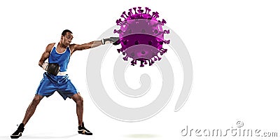 Professional sportsman kicking, punching coronavirus model - fight the desease, flyer Stock Photo