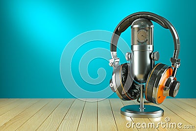 Professional studio microphone and headphones on wooden table Stock Photo