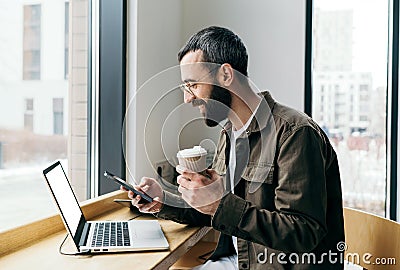 Professional, stylish man working remotely in a modern cafe Stock Photo