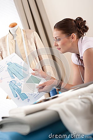 Professional tailor holding fashion sketch Stock Photo