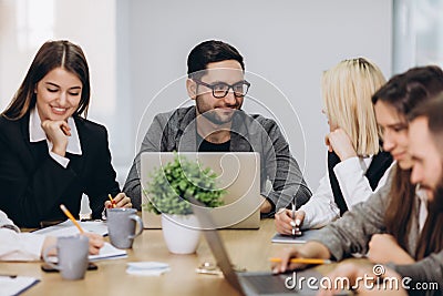 Professional team. Happy creative young people working in team while being at the office Stock Photo