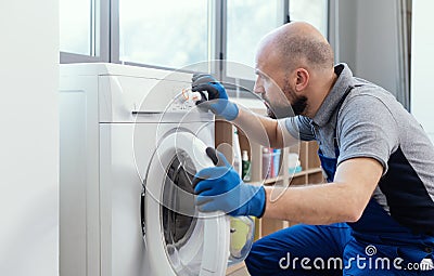 Professional technician checking a washing machine Stock Photo