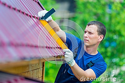 Professional with the tool repairs the roof Stock Photo
