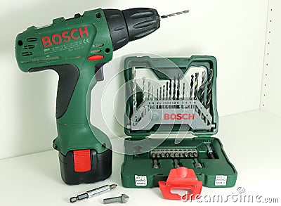 A professional tools of Bosch - one green cordless drill accumulator drill and a set of drill bits. Editorial Stock Photo