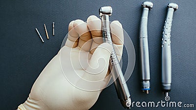 Tools dentist hand holding dental handpiece Stock Photo