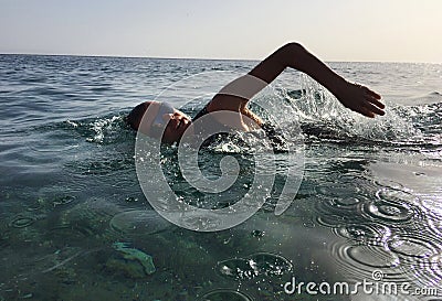 Professional triathlete practicing in open water. Swimming in se Stock Photo