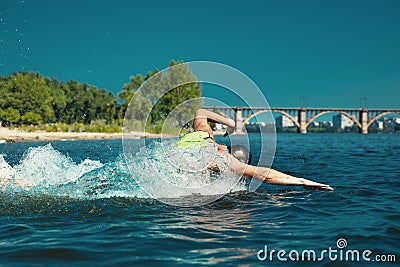 Professional triathlete swimming in river`s open water Stock Photo
