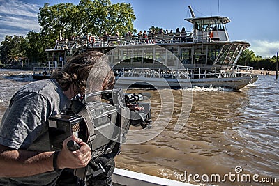 Video cameraman working with his professional equipment. Editorial Stock Photo