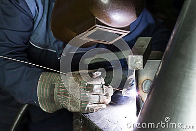 Professional welder welding metal parts Stock Photo
