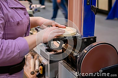 Professional woman carpenter hands using belt sander machine Stock Photo