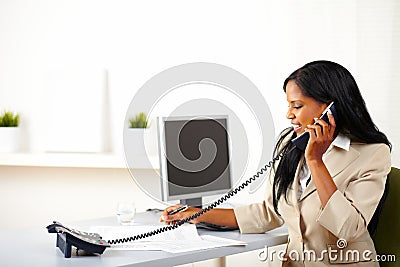 Professional woman conversing on phone Stock Photo