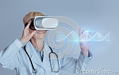 Professional woman doctor in VR glasses studying blue glowing virtual human DNA strand, using futuristic CRISPR method Stock Photo