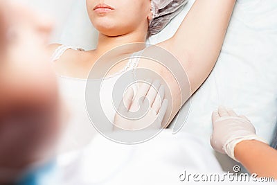 Professional woman at spa doing epilation armpits using sugar, sugaring Stock Photo