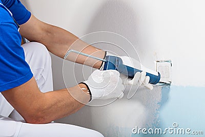 Professional Workman Applying Silicone Sealant With Caulking Gun Stock Photo