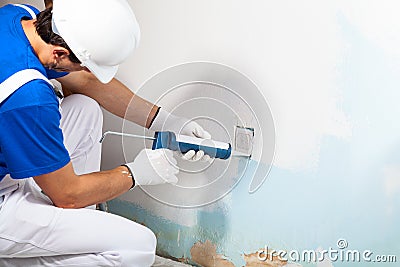 Professional Workman Applying Silicone Sealant With Caulking Gun Stock Photo