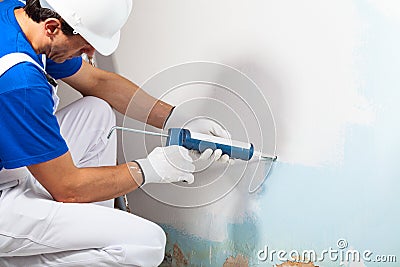 Professional Workman Applying Silicone Sealant With Caulking Gun Stock Photo