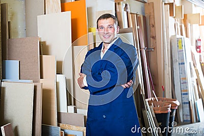 Professional workman standing with plywood pieces Stock Photo