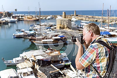 Proffesional photographer taking photo in marina Stock Photo