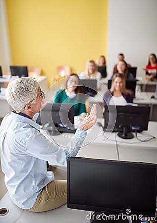 Proffessor talking with her pupils Stock Photo