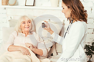 Proficient medical doctor giving medicament to patient in the hospital Stock Photo
