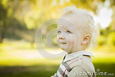 Profile of Adorable Blonde Baby Boy Outdoors Stock Photo